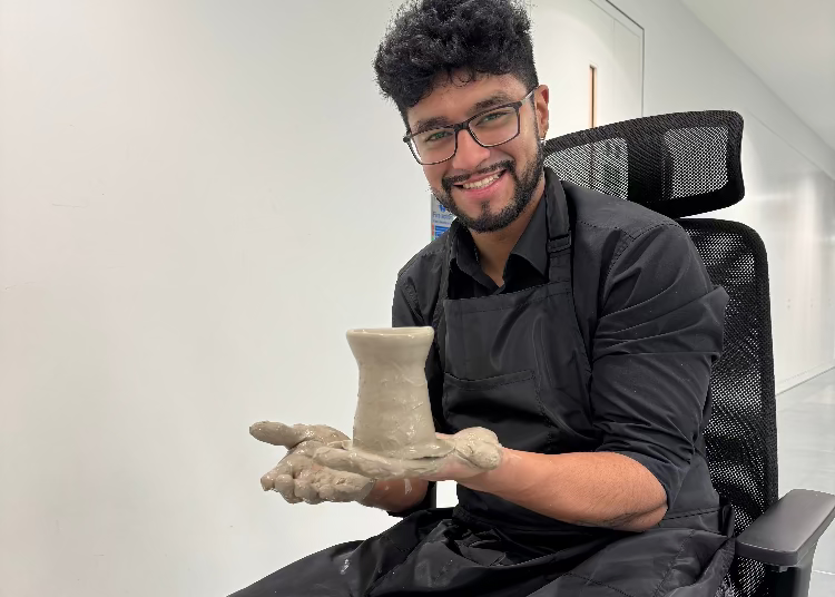 Person holding a clay pot in an office setting